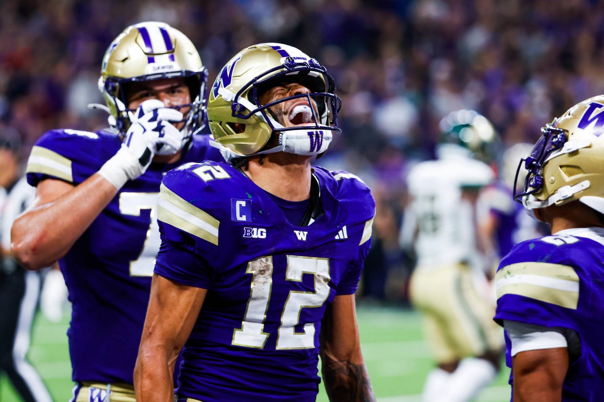 Washington Huskies wide receiver Denzel Boston (12) celebrates after catching a touchdown pass against the Colorado State Rams.