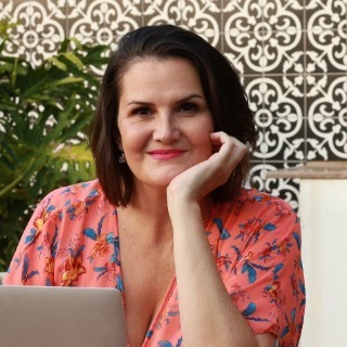 Tamryn, your host, smiling at her laptop